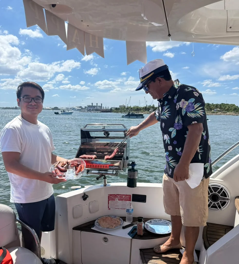 Guests enjoying an onboard gathering beside a grill